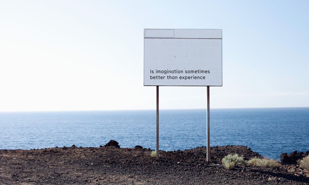Sign at a cliff at the sea